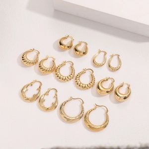 Set of 14K gold plated earrings featuring smooth, spiral and croissant textured designs