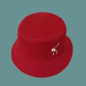 Detailed close-up of white skeleton dab embroidery on a dark red cotton bucket hat