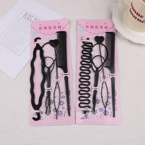 Detailed set of 5 black plastic hair styling tools on floral decorative card packaging