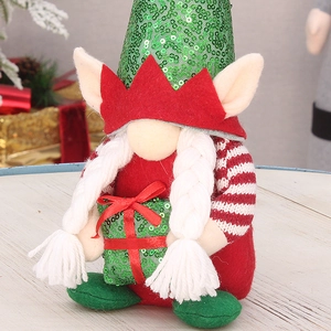 Close-up of a Christmas gnome doll with green sequin hat and white braided pigtails