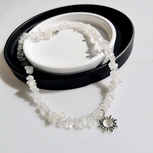 Chic irregular stone sunflower necklace with silver sun pendant on a display tray
