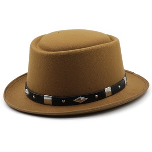 Detail of camel wool pork pie hat featuring a black leather band with silver metal studs