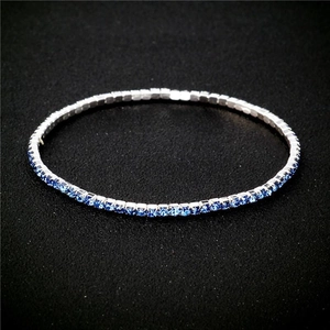 Detail shot of a 2.0mm elastic tennis bracelet featuring blue rhinestones and silver metal