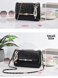 Detail of black woven shoulder bag in two sizes with pearl bow charm and gold chain