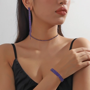 Detail view of gold bridal jewelry set with navy blue rhinestones on model