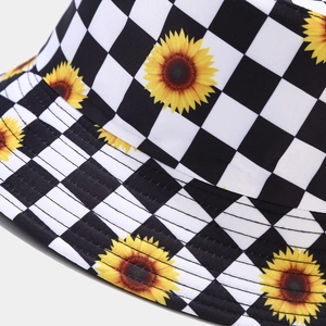 Daisy patterned checkerboard bucket hat for men and women featuring a reversible sun design