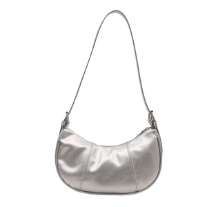 Silver crescent hobo bag with metallic finish and vertical stitching detail on white background