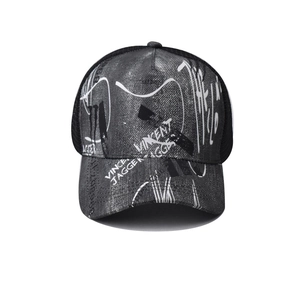 Detail of grey washed denim trucker hat with Vincent Jagger embroidery and black mesh back