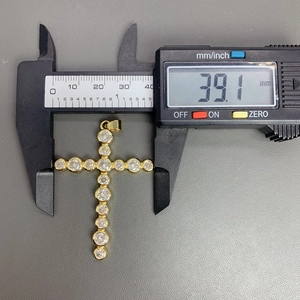 Detailed measurement of gold cross pendant showing a height of 39.1mm with zircon crystals