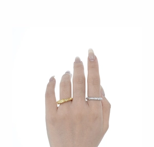 Detail of minimalist 925 silver rings with irregular lava texture in gold and silver finish