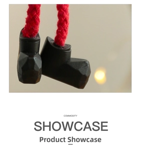 Detail of cute Christmas elf doll boots with red braided rope for tree hanging ornaments