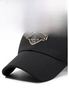 Close-up of black canvas baseball cap featuring vintage gold embroidery and firm brim