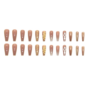 Detailed set of long ballerina press-on nails with snake charms and gold glitter
