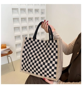 Detail of checkered linen tote bag with reinforced handles and jute textured sides