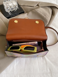 Brown snake pattern flap bag with iridescent body showing spacious interior compartments