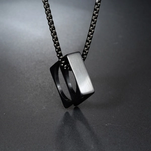 Minimalist black square ring pendant necklace with brushed metal finish on a long chain