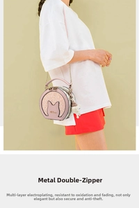 Detail of pink round shoulder bag featuring metallic dual zippers and cat ear sequin design