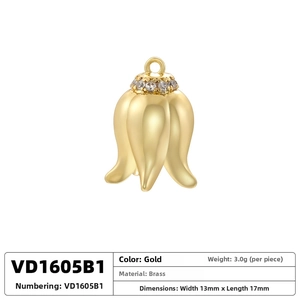Macro view of gold lily of the valley pendant with cubic zirconia and brass specs
