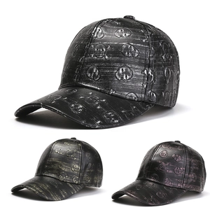 Detailed view of skull-patterned baseball caps with metallic finish and texture