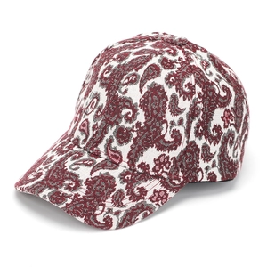 Macro detail of vintage burgundy paisley jacquard fabric on a structured baseball cap