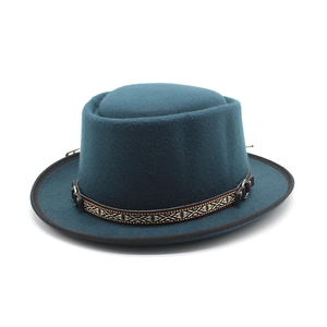 Detail of wool pork pie hat featuring ethnic woven band and leather buckle closure