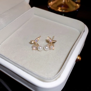 Elegant cherry pearl earrings with micro-set zircon and gold-tone leaf on a velvet box