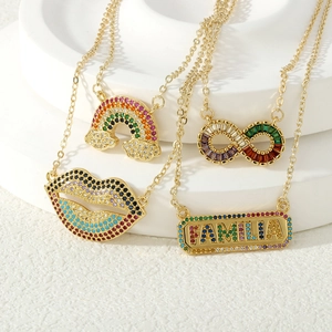 Detailed shot of gold pendants with colorful zircons in rainbow, lip, and infinity shapes