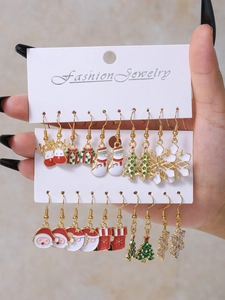 Close-up of 12 pairs of Christmas earrings including Santa Claus and snowflake designs