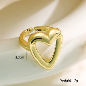 Macro shot of gold heart-shaped adjustable ring with detailed size and weight labels