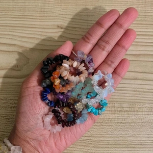 Elastic rings made of irregular natural amethyst, quartz, and tiger eye stones in hand