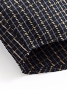 Gros plan sur le tissu à carreaux bleu marine avec détails de tissage jaune et gris