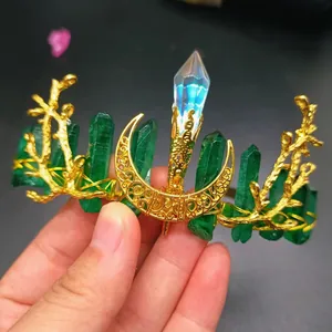 Handmade golden crystal crown with green gemstones and a central iridescent crystal pillar