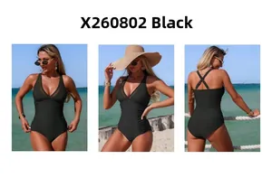 Detail view of black mesh one-piece swimsuit with ruching and adjustable cross straps