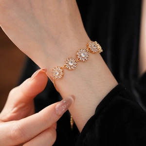 Close-up of vintage golden flower bracelet with zircons on a model wrist