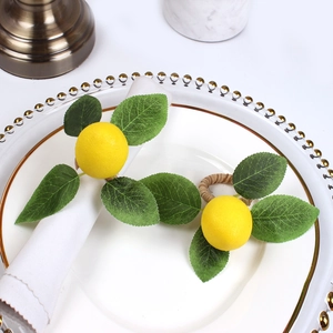 Handmade lemon napkin rings with realistic yellow fruit and green leaves on woven base