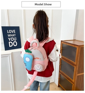 Detailed view of pink toddler backpack with 3D carrot pocket and cute bunny accessory