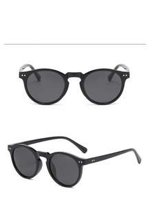 Front and side view of classic black round frame sunglasses with metallic rivet detail