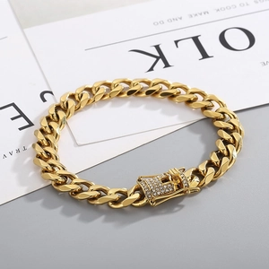 Detailed macro shot of a gold-plated Cuban chain bracelet with a luxury diamond-set clasp