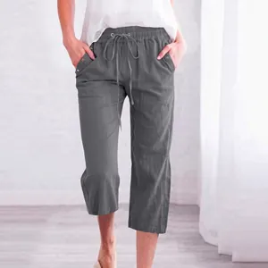 Detail of dark grey linen shorts featuring an adjustable drawstring elastic waistband