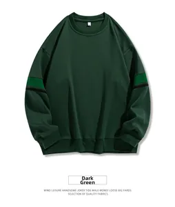 Detail view of dark green crewneck sweatshirt with ribbed cuffs and color-block stripes
