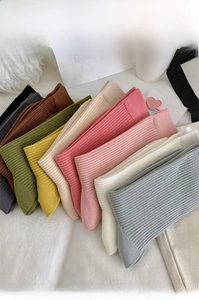 Detailed close-up of colorful ribbed knit crew socks in various Morandi color tones