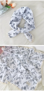 Close-up of cotton linen floral scarf with white lace trim and natural texture
