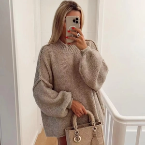 Close-up of oatmeal oversized knit sweater featuring a round neck and relaxed silhouette