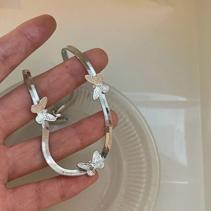 Silver snake chain necklace featuring 3D metal butterfly charms with polished finish