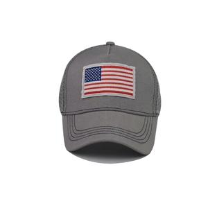 Detail of American flag embroidery patch on grey mesh trucker baseball hat