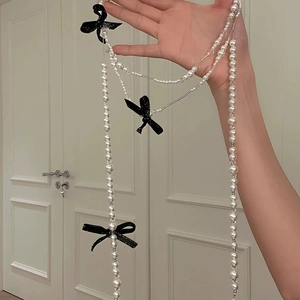 French vintage pearl necklace with black glitter bows for elegant layered styling