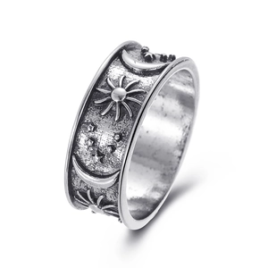 Detailed view of vintage silver ring featuring celestial sun, moon, and star engravings
