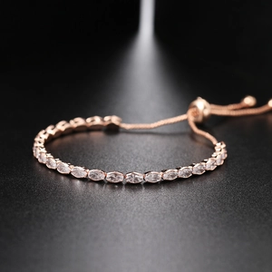 Macro view of adjustable rose gold tennis bracelet with marquise-cut white zircons