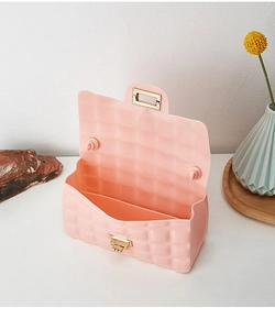 Detailed view of pink quilted PVC jelly bag with gold metal rotating lock and handle