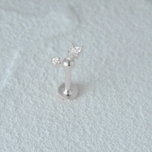 Macro view of silver flat back cartilage stud with square and round clear gems